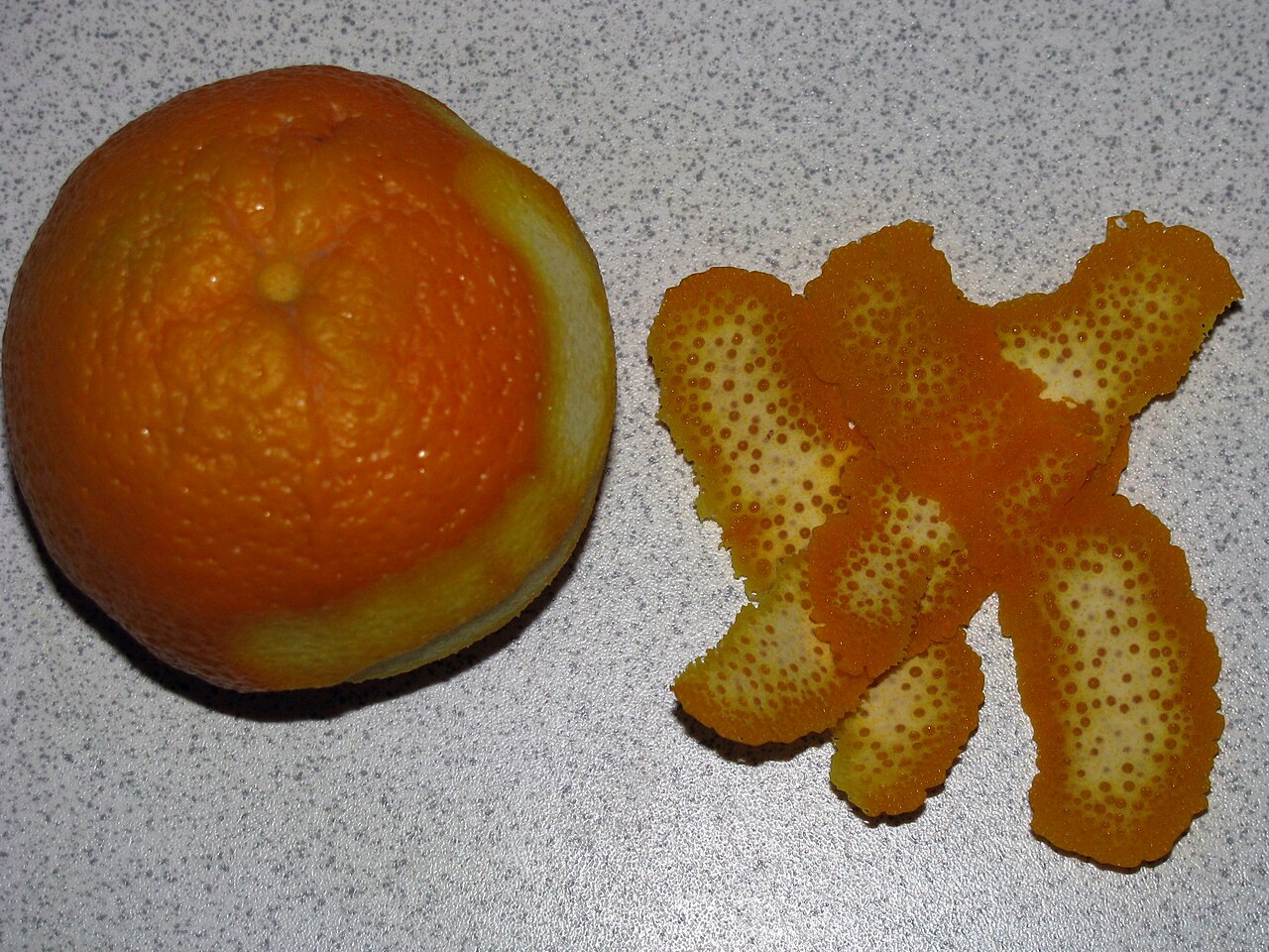 Close-up of a fresh orange peel's textured surface