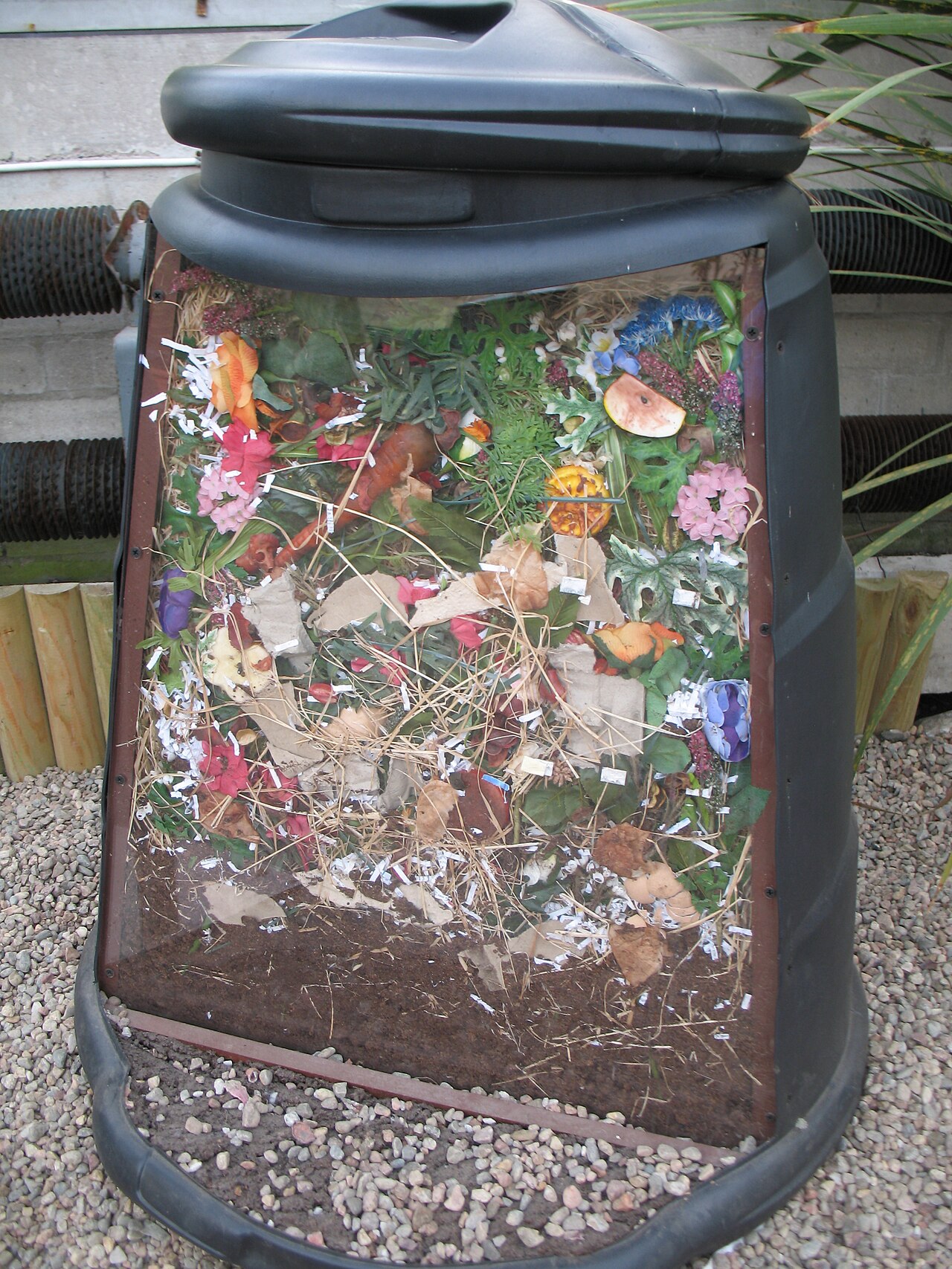 Cutaway compost bin showing alternating layers of material